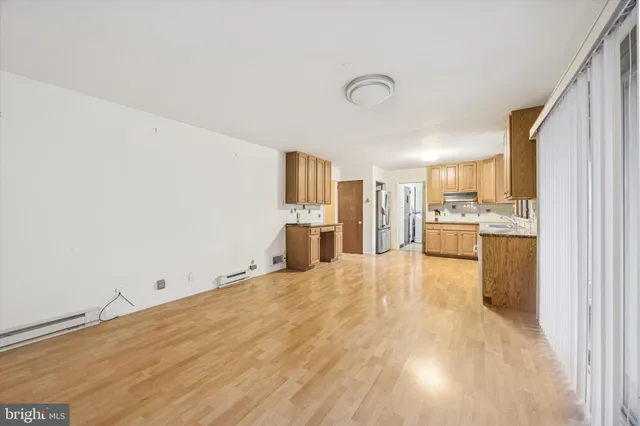 a view of a kitchen with refrigerator and windows
