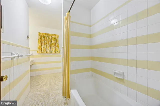 a bathroom with a bathtub and shower