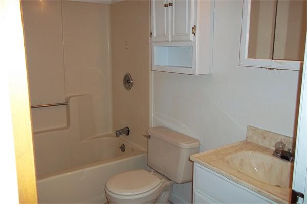 34 Farmland Road, Unit D Lowell, MA 01850 - Photo 7 of 10 a white toilet sitting next to a bath tub