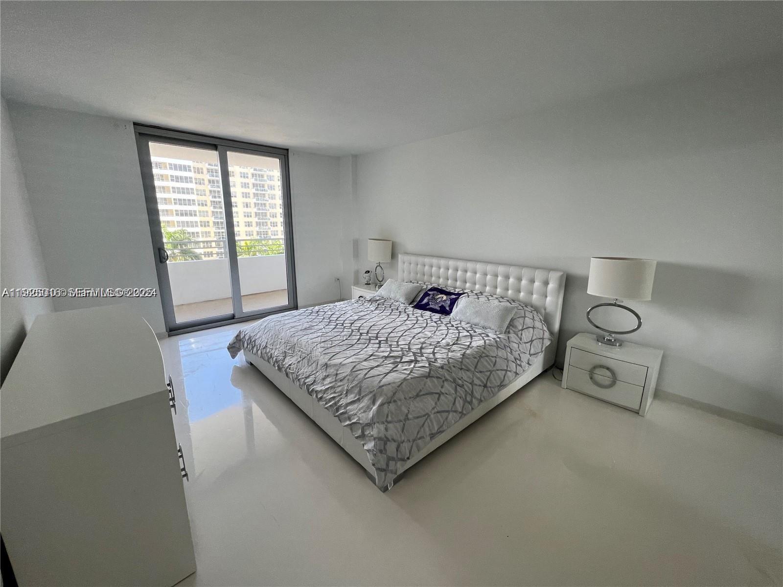5555 Collins Avenue, Unit 7T Miami Beach, FL 33140 - Photo 12 of 19 a bedroom with a bed and window