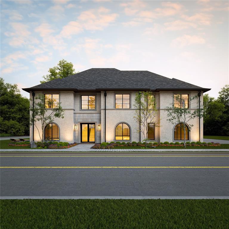 a front view of a house with a garden