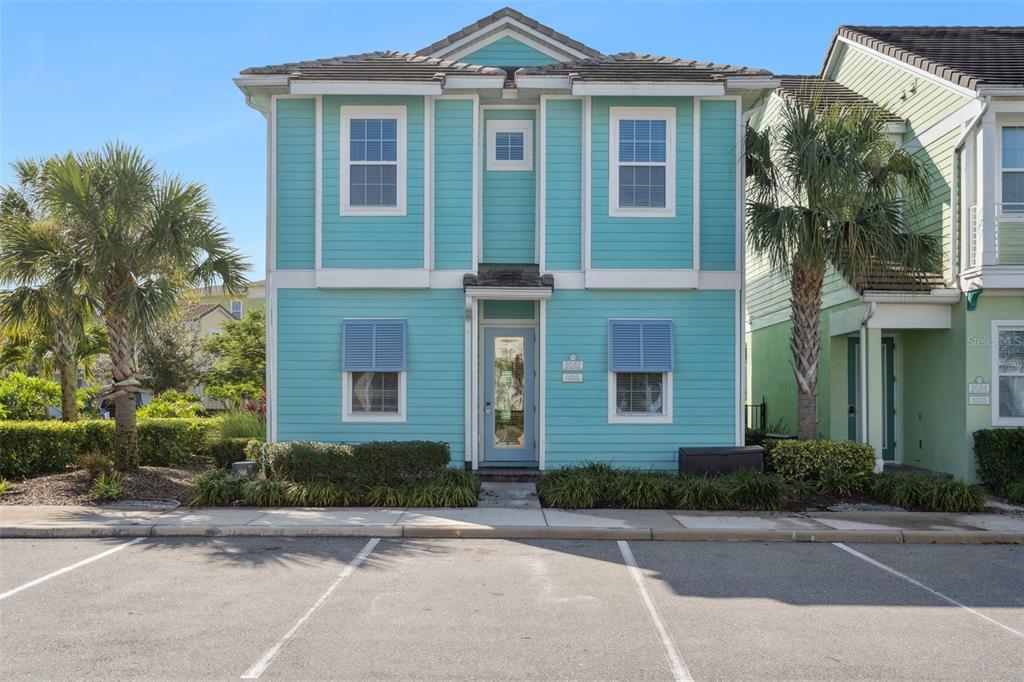 front view of a brick house with a small yard