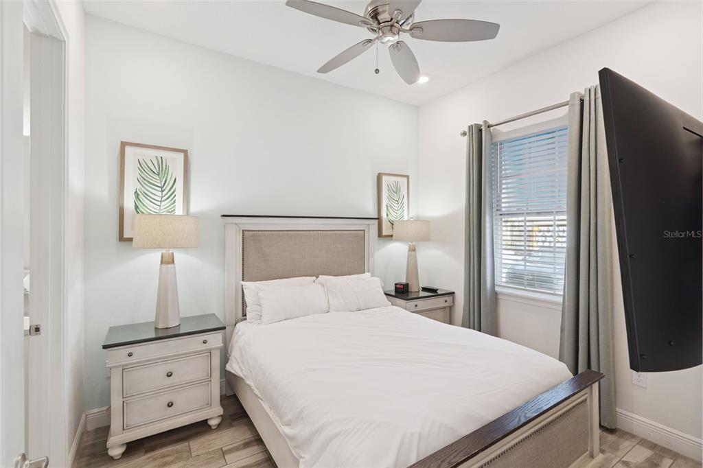 8082 Knee Deep Road Kissimmee, FL 34747 - Photo 12 of 30 a bedroom with a bed and wooden floor
