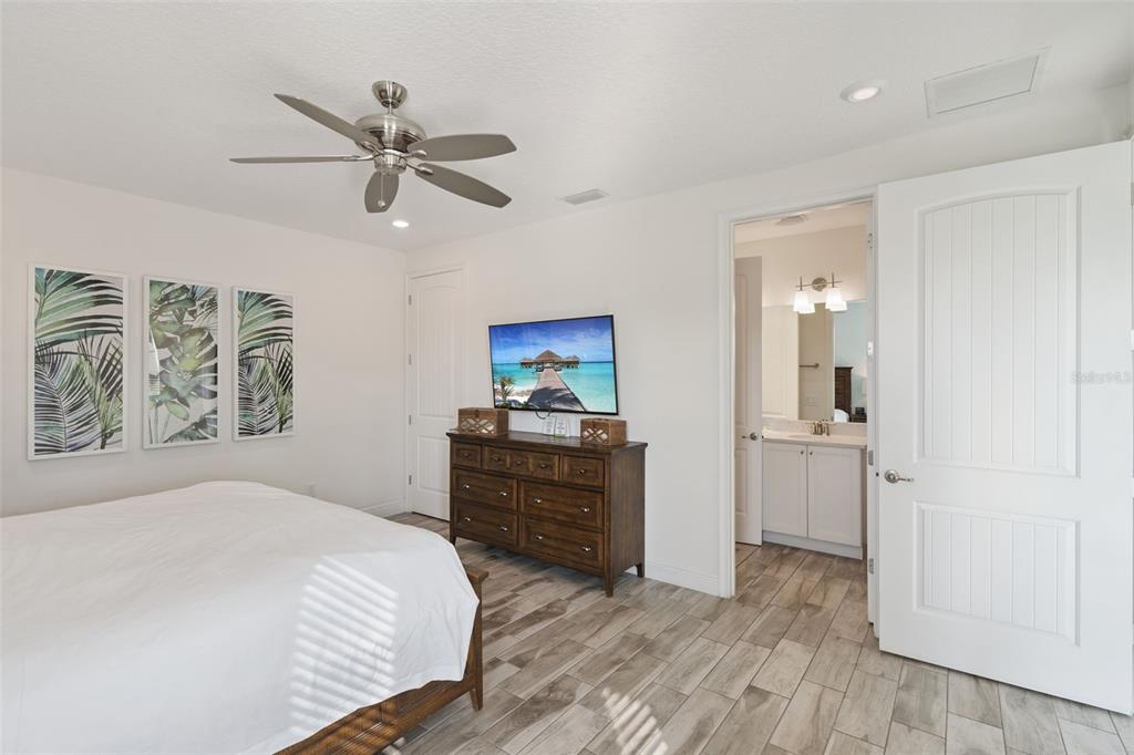 8082 Knee Deep Road Kissimmee, FL 34747 - Photo 17 of 30 a bedroom with a bed and a mirror