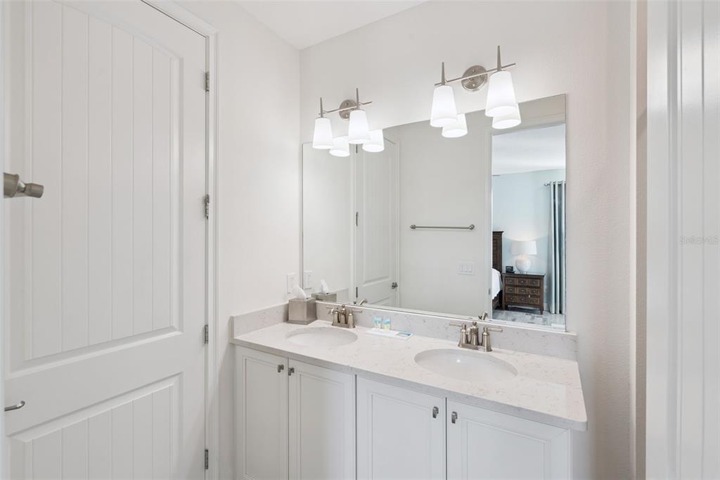 8082 Knee Deep Road Kissimmee, FL 34747 - Photo 19 of 30 a bathroom with a sink vanity and mirror