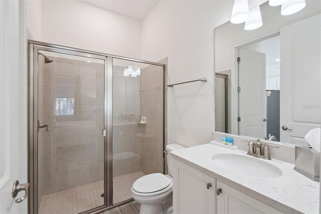 8082 Knee Deep Road Kissimmee, FL 34747 - Photo 20 of 30 a bathroom with a sink a toilet and shower