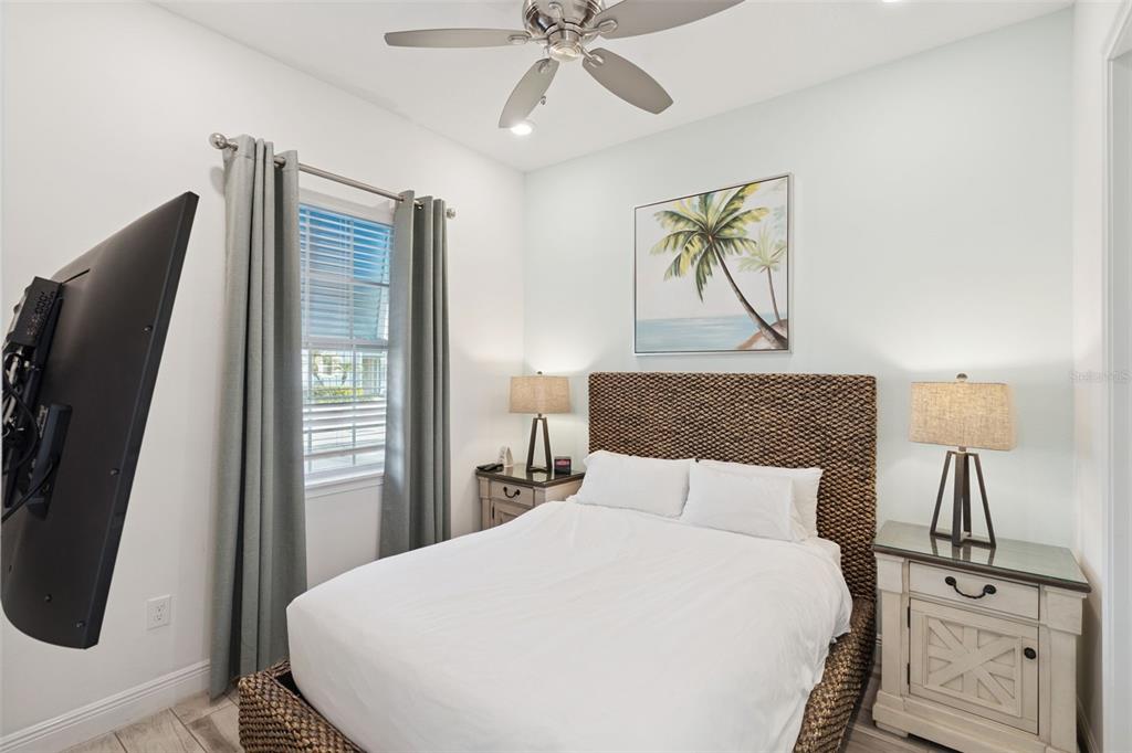 8082 Knee Deep Road Kissimmee, FL 34747 - Photo 22 of 30 a bedroom with a bed and a chandelier