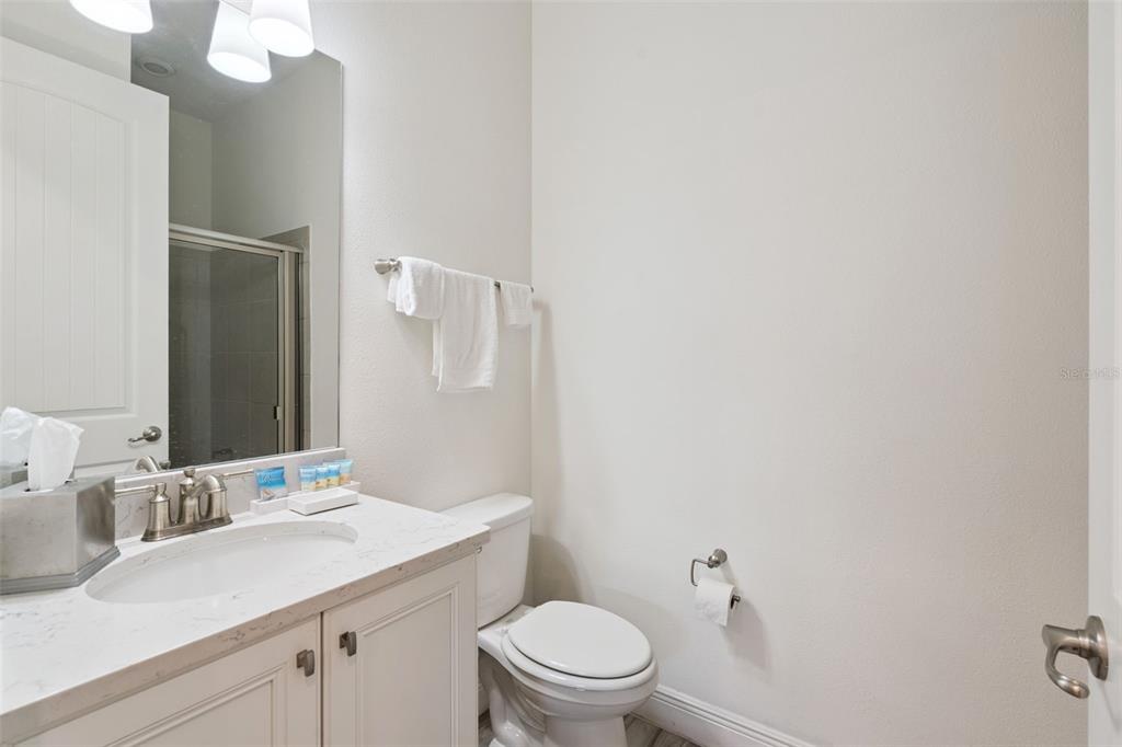 8082 Knee Deep Road Kissimmee, FL 34747 - Photo 23 of 30 a bathroom with a sink a toilet and a mirror