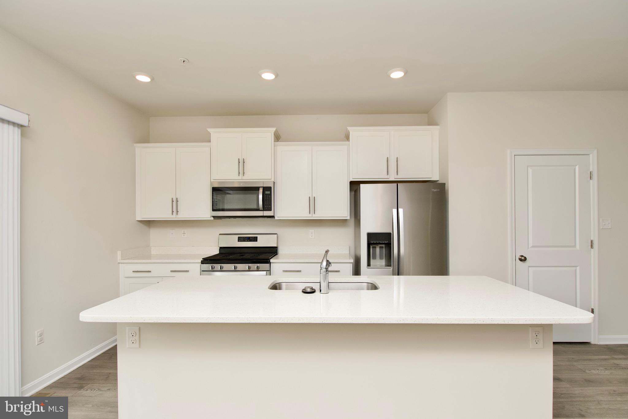 2023 Cross Church Way Bowie, MD 20721 - Photo 11 of 30 a kitchen with stainless steel appliances a sink a stove a refrigerator and cabinets