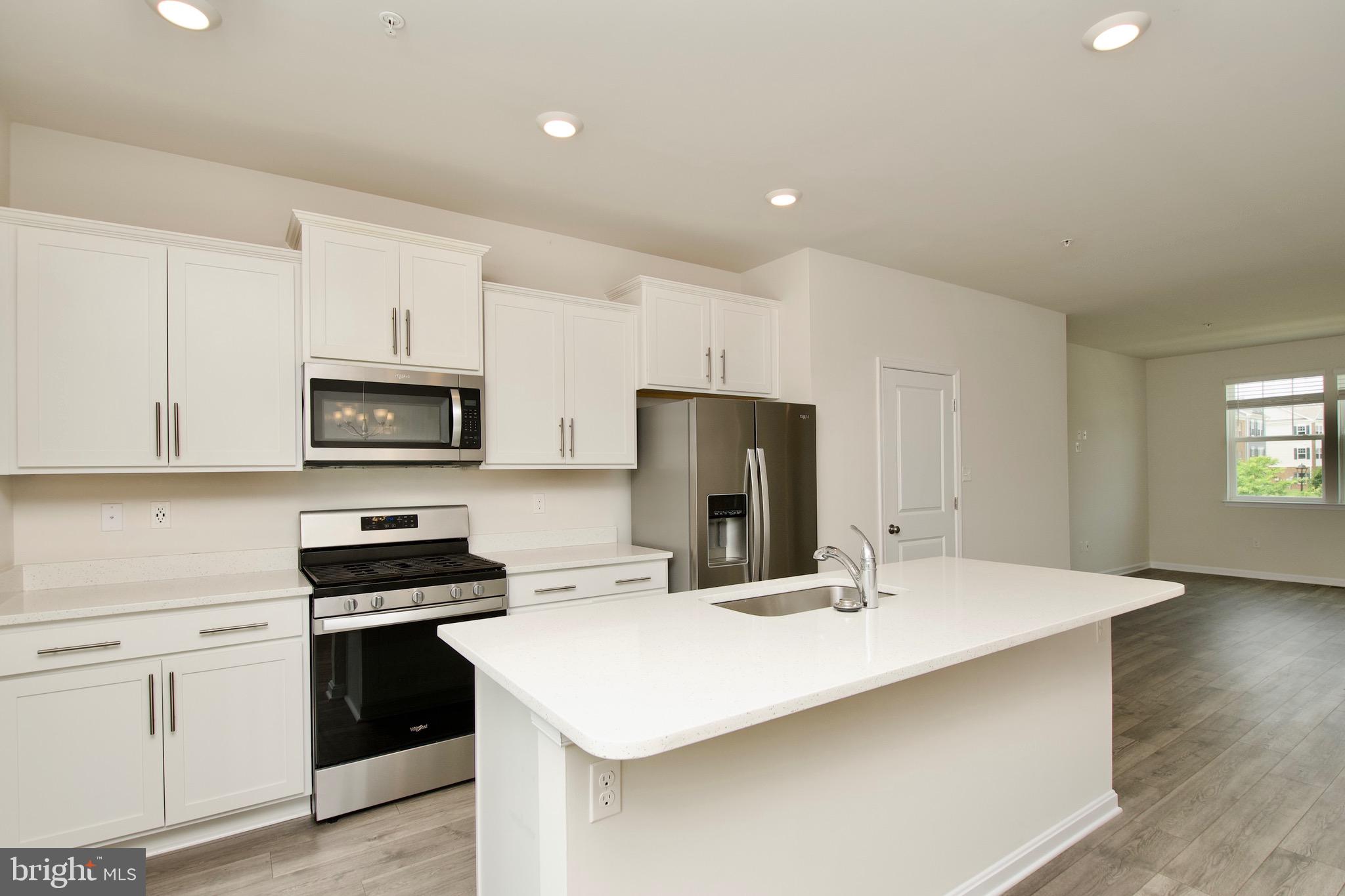 2023 Cross Church Way Bowie, MD 20721 - Photo 12 of 30 a kitchen with stainless steel appliances a stove refrigerator sink and cabinets