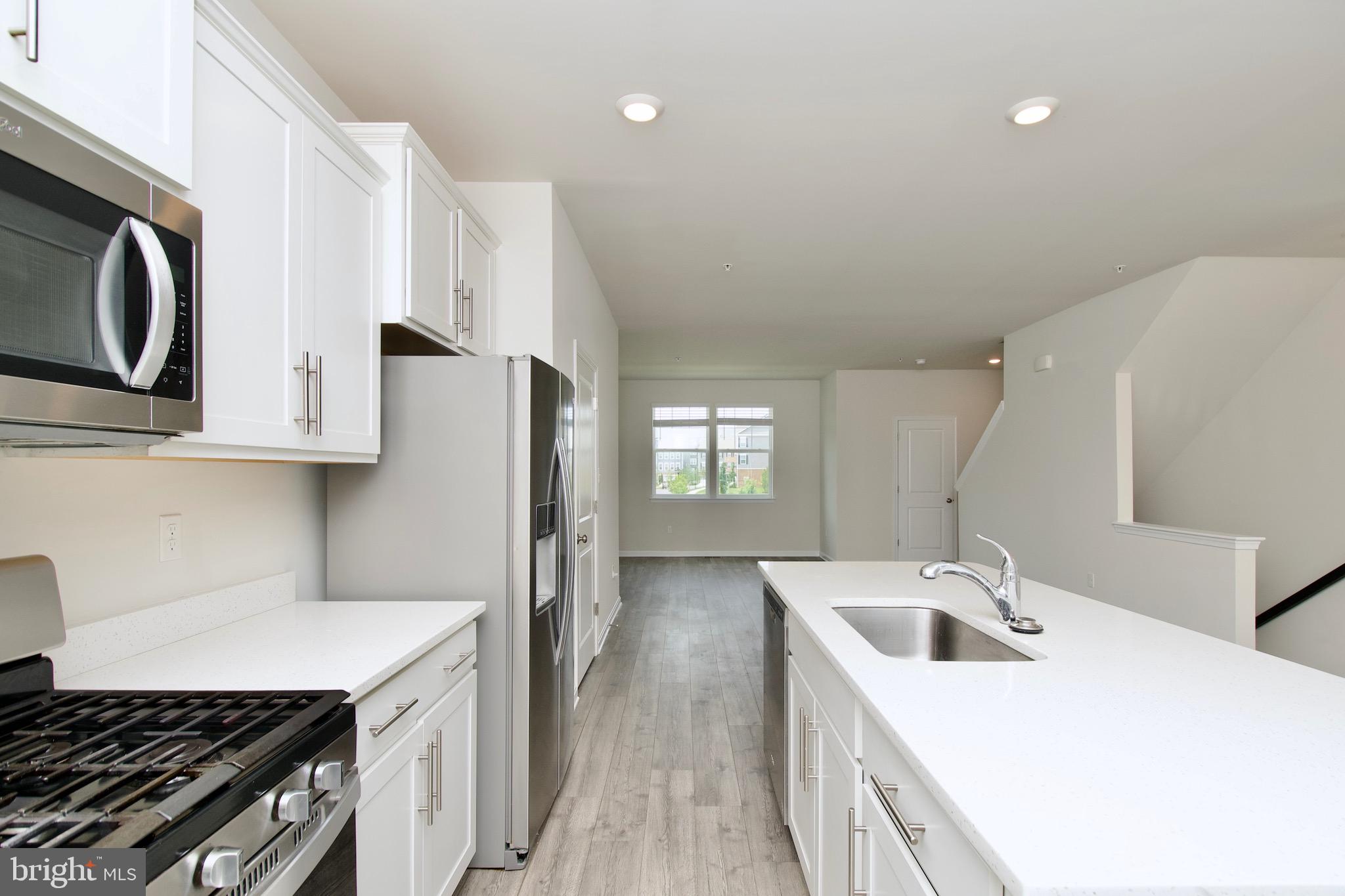 2023 Cross Church Way Bowie, MD 20721 - Photo 13 of 30 a kitchen with stainless steel appliances granite countertop a sink stove and refrigerator