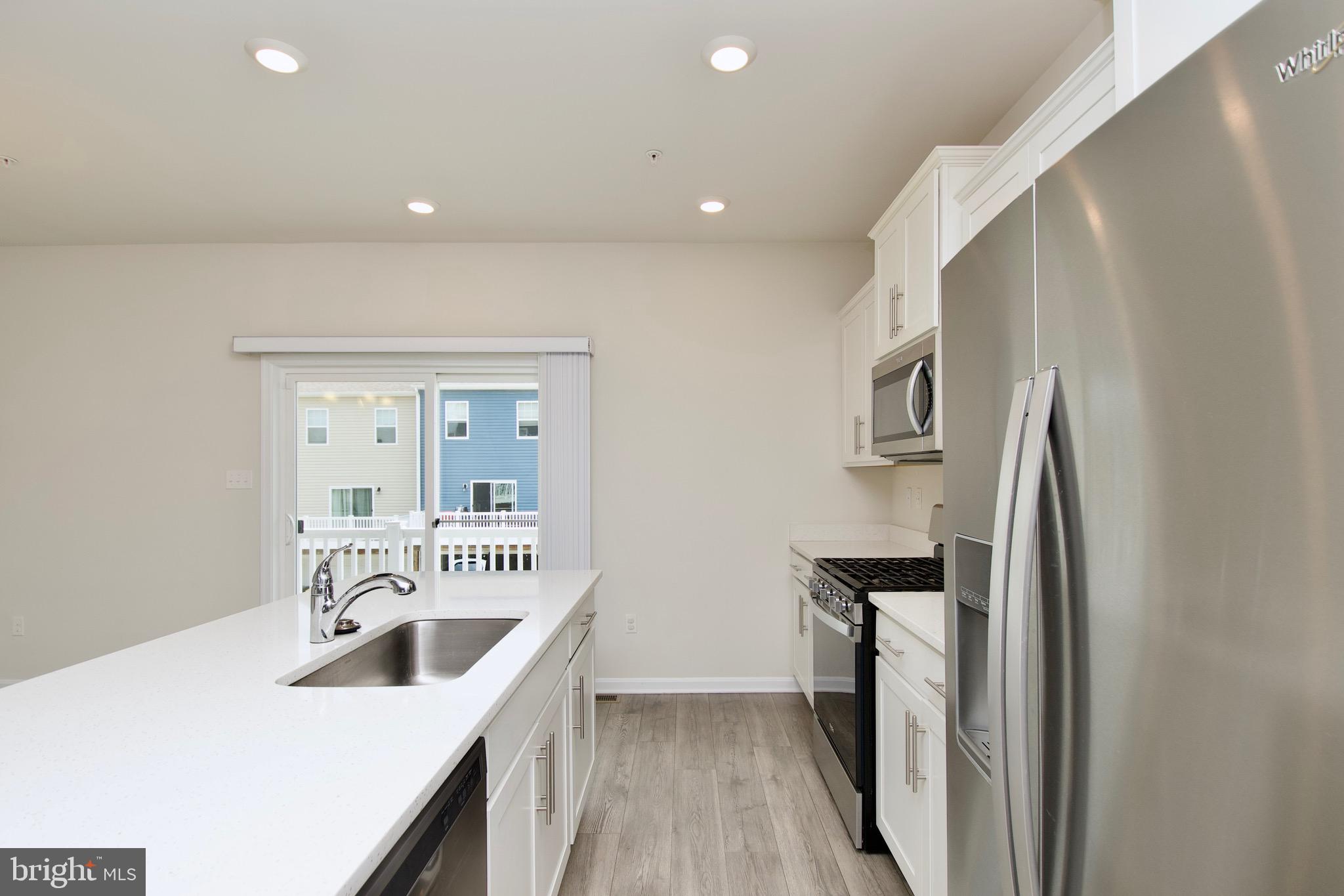 2023 Cross Church Way Bowie, MD 20721 - Photo 14 of 30 a kitchen with a sink a refrigerator and a stove top oven