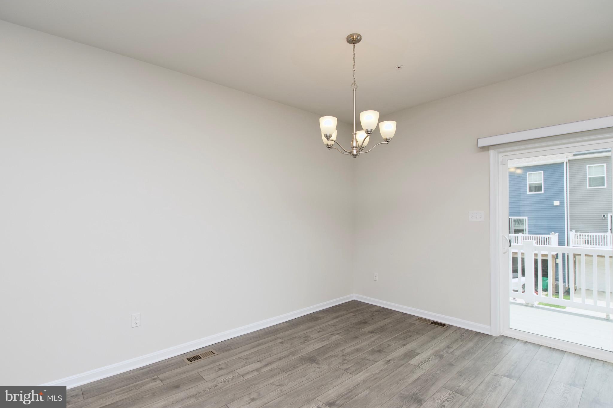2023 Cross Church Way Bowie, MD 20721 - Photo 15 of 30 a view of a room with wooden floor and chandelier