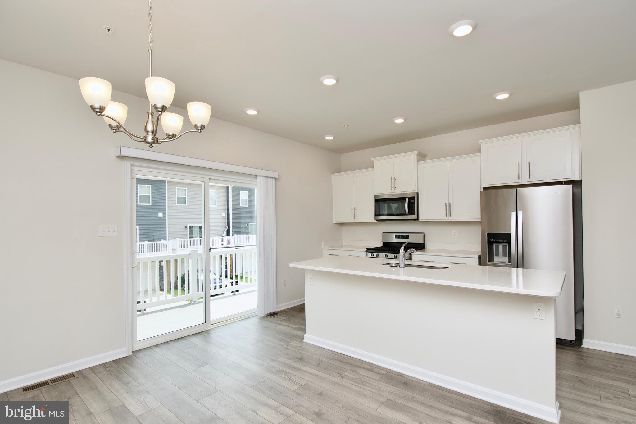 2023 Cross Church Way Bowie, MD 20721 - Photo 16 of 30 a kitchen with stainless steel appliances a refrigerator sink and microwave
