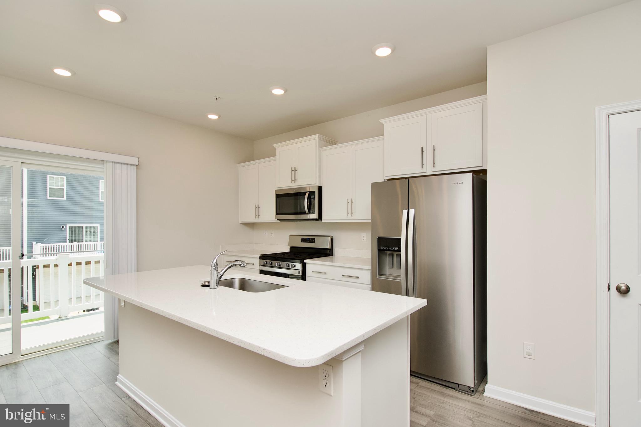 2023 Cross Church Way Bowie, MD 20721 - Photo 10 of 30 a kitchen with stainless steel appliances a sink and a refrigerator