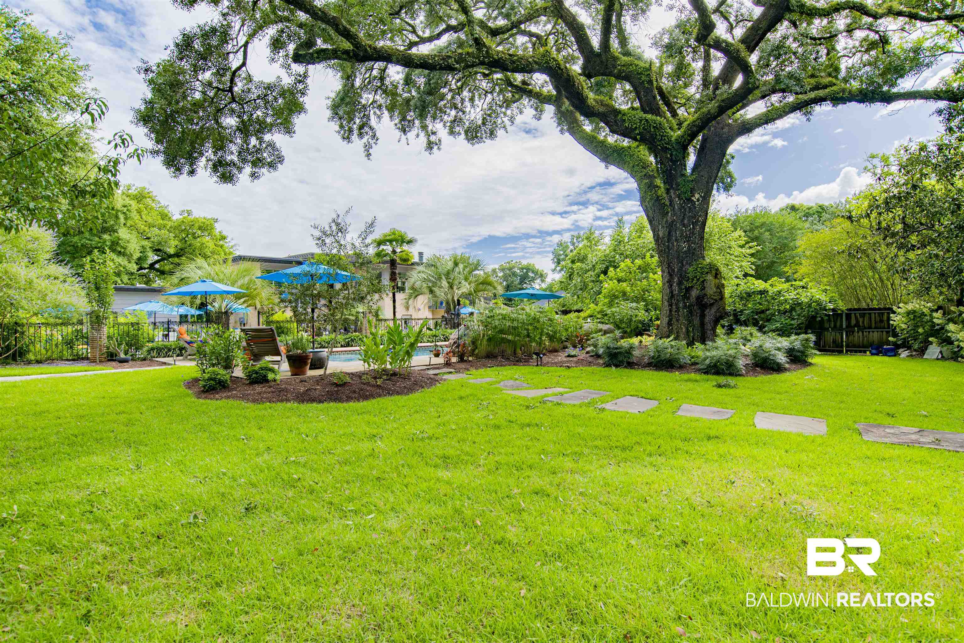 809 Bernard Circle Mobile, AL 36693 - Photo 69 of 75 Expansive green lawn featuring a mature tree, stepping stones, and perimeter landscaping
