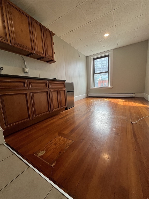 868 Beacon Street, Unit 14 Boston, MA 02215 - Photo 1 of 5 a view of an empty room with wooden floor and a window