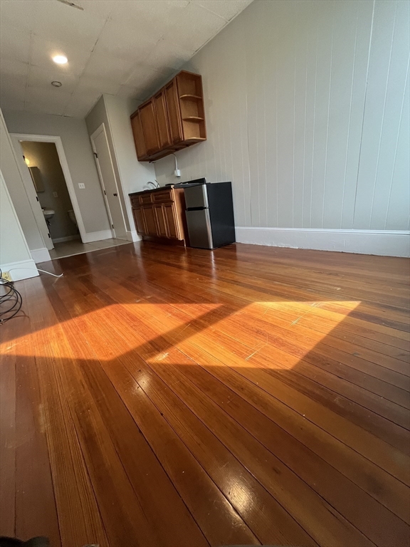 868 Beacon Street, Unit 14 Boston, MA 02215 - Photo 3 of 5 a view of an empty room with wooden floor