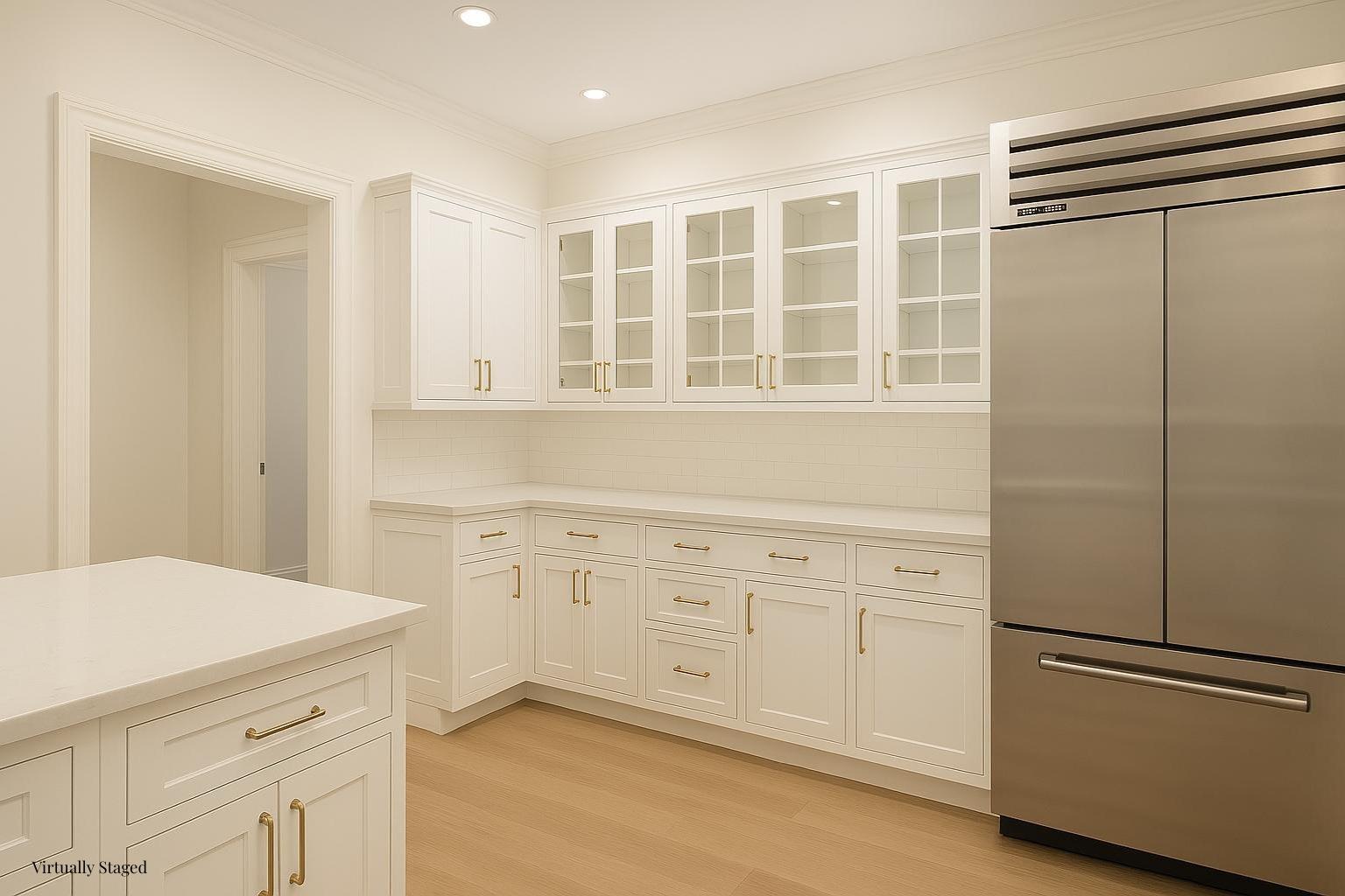 550 Park Avenue, Unit 12E Manhattan, NY 10065 - Photo 9 of 29 a kitchen with a refrigerator and white cabinets