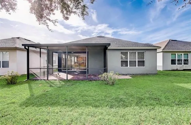 a view of a house with backyard porch and garden