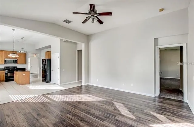 a view of a kitchen with a sink and a refrigerator