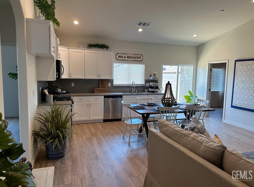 Undisclosed Address Bakersfield, CA 93314 - Photo 5 of 12 a living room with furniture kitchen view and a wooden floor