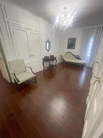 a living room with furniture and a chandelier