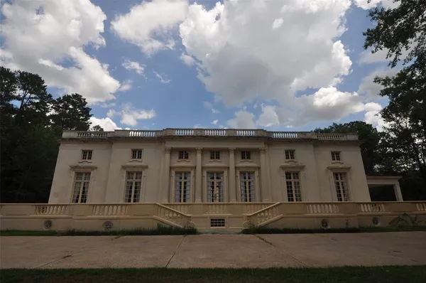 a front view of a house with a garden