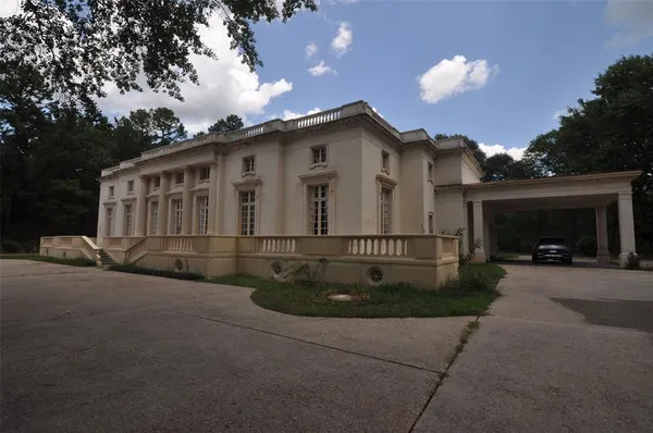 a view of a house with a garden and pathway