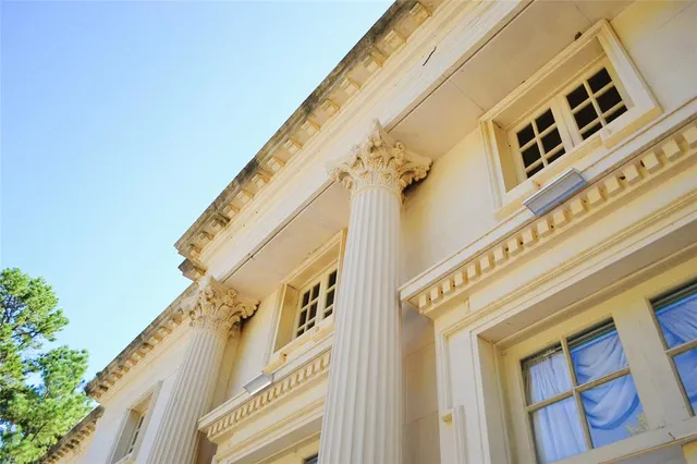 a bedroom with a bed chair and window