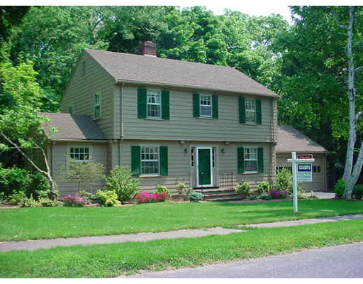 28 Denton Road Wellesley, MA 02482 - Photo 1 of 1 a front view of a house with a garden and plants