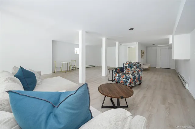a living room with furniture and a dining table