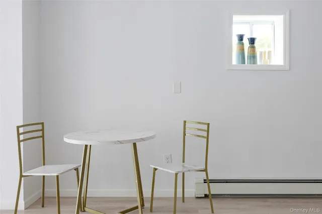 a view of a hallway with front door and wooden floor