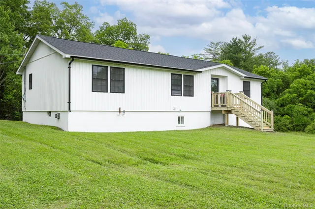 a view of a backyard with plants and a garden