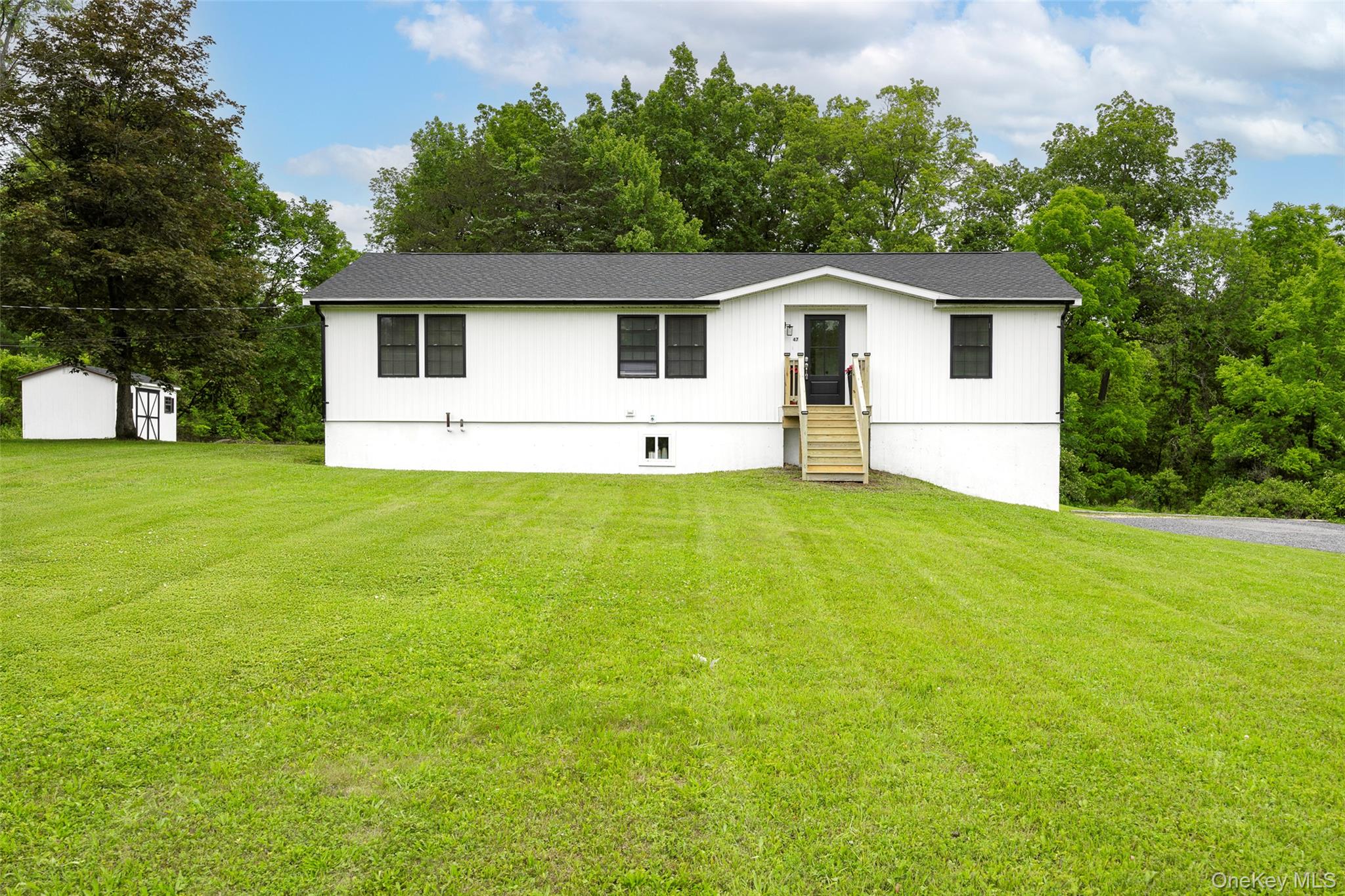 47 Clay Hill Road Tivoli, NY 12583 - Photo 42 of 43 a front view of house with yard and trees in the background