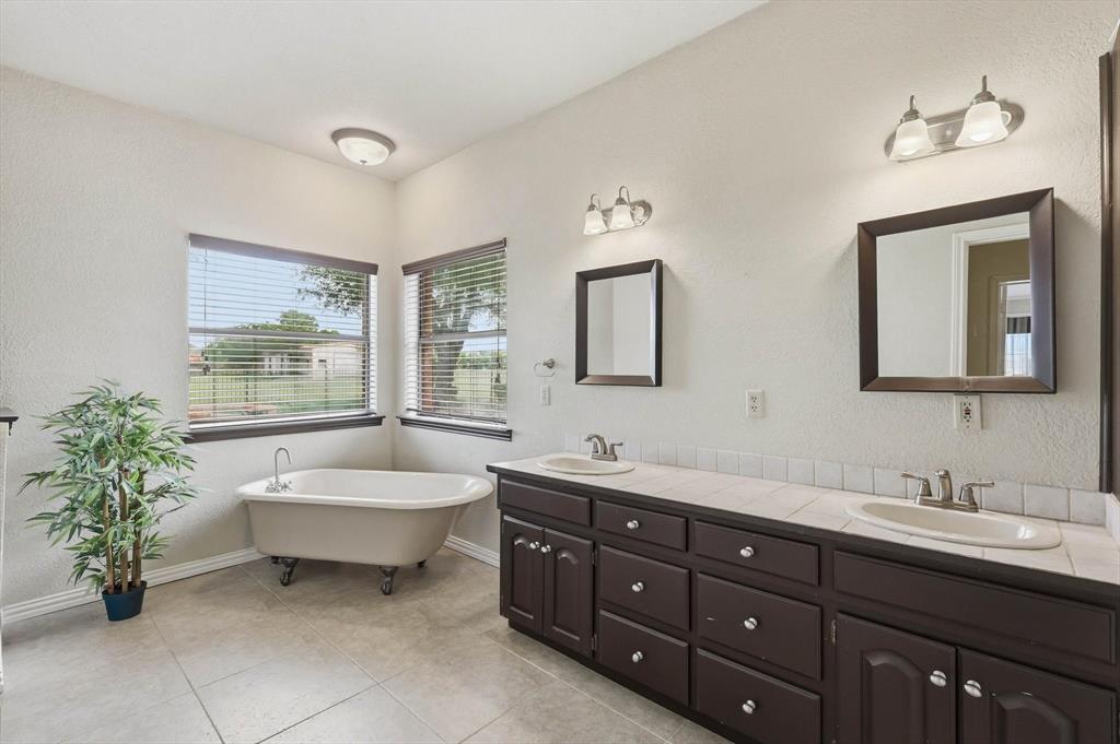 211 Bayne Road Haslet, TX 76052 - Photo 16 of 29 a spacious bathroom with a double vanity sink and a mirror