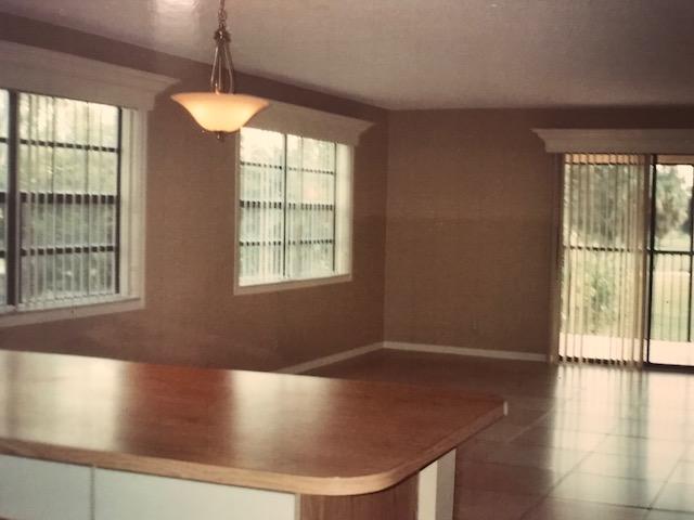 1400 Northwest 45th Street, Unit B5 Pompano Beach, FL 33064 - Photo 2 of 9 a view of livingroom with furniture wooden floor and windows