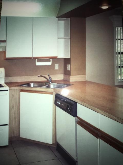 1400 Northwest 45th Street, Unit B5 Pompano Beach, FL 33064 - Photo 6 of 9 a kitchen with a sink and cabinets