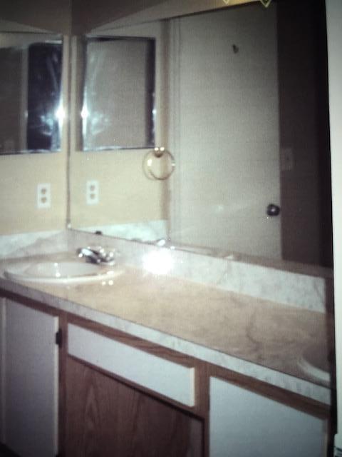 1400 Northwest 45th Street, Unit B5 Pompano Beach, FL 33064 - Photo 7 of 9 a bathroom with a sink and a mirror