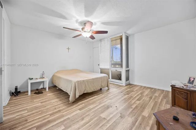 a spacious bedroom with a bed and a chandelier