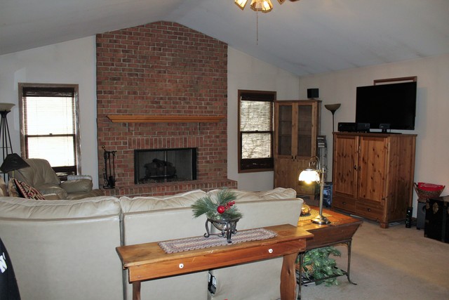 148 Fernwood Road Montgomery, IL 60538 - Photo 5 of 19 a living room with furniture a flat screen tv and a fireplace