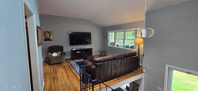 a living room with furniture and a flat screen tv