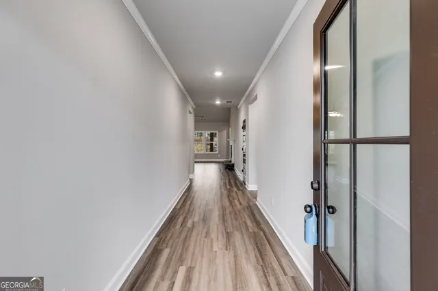 a view of hallway with wooden floor