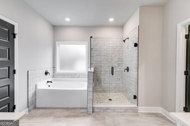 a bathroom with a sink double vanity mirror and bathtub