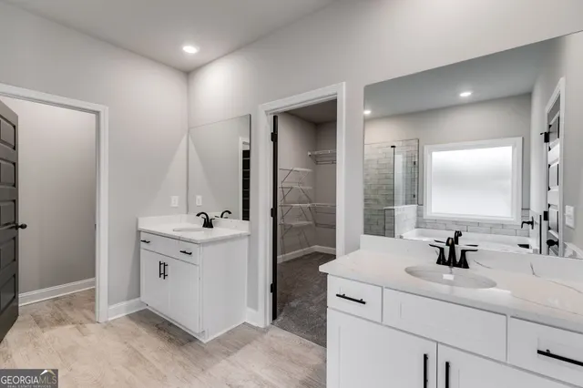 a bathroom with a tub sink and mirror
