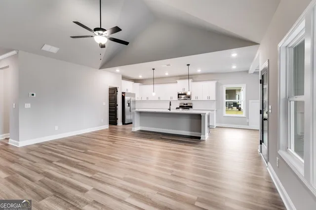 a view of a kitchen with a sink and a large window