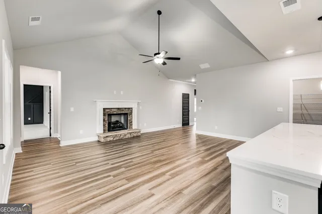 a view of an empty room with a fireplace and a chandelier