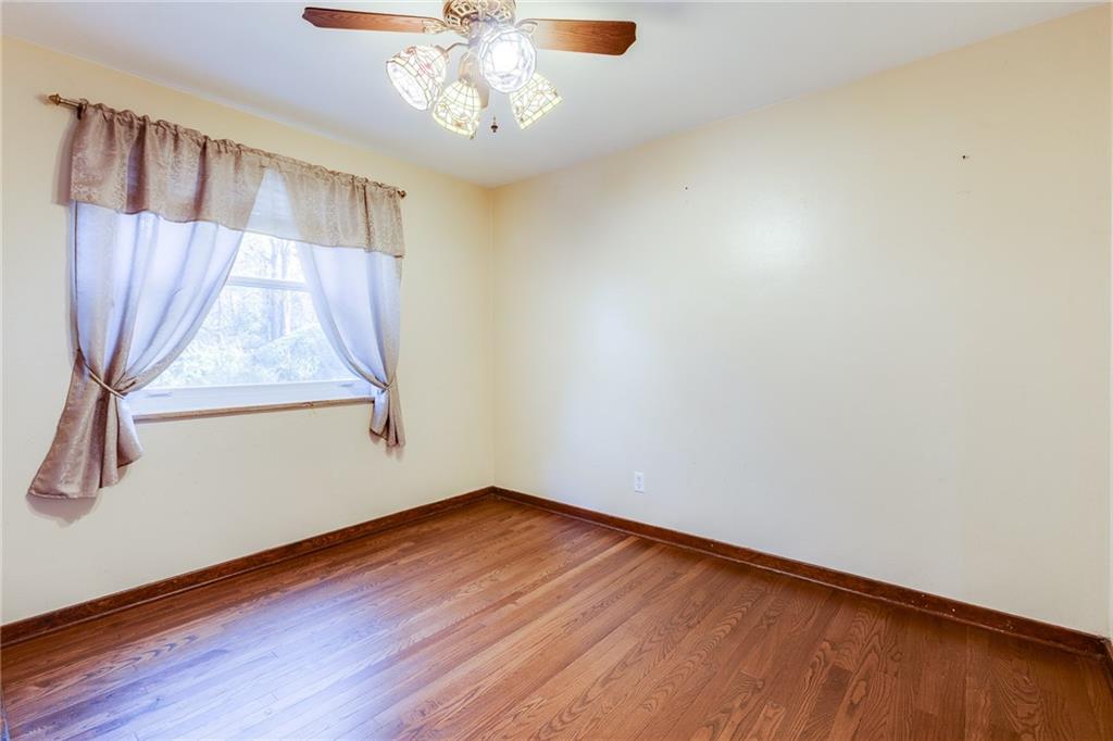 133 Hamburg Street Pittsburgh, PA 15220 - Photo 12 of 41 wooden floor in an empty room with a window