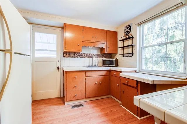 a kitchen with stainless steel appliances granite countertop a refrigerator and a sink