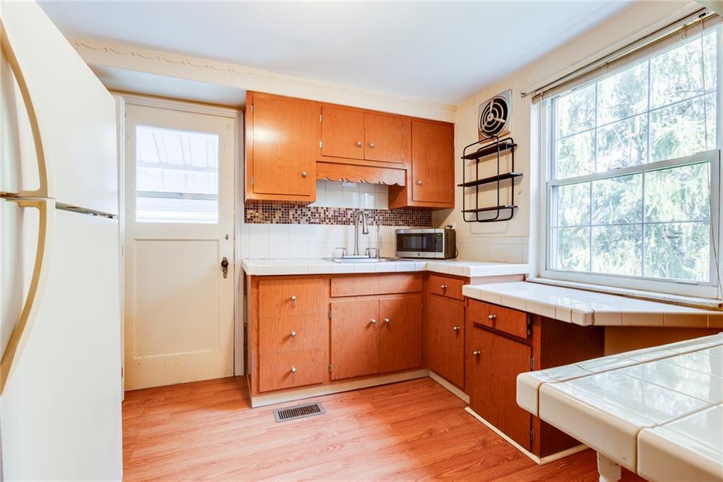 133 Hamburg Street Pittsburgh, PA 15220 - Photo 13 of 41 a kitchen with stainless steel appliances granite countertop a refrigerator and a sink